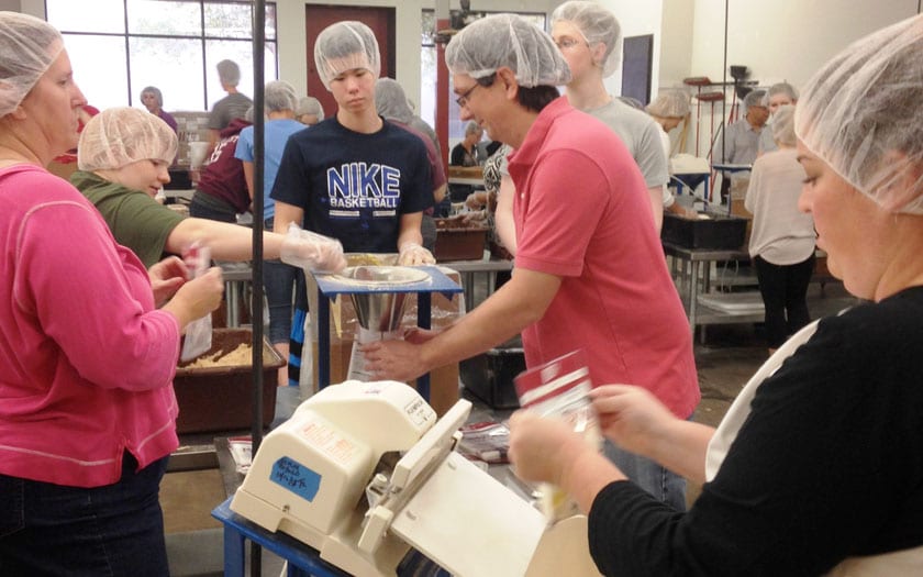 Students and Staff pack meals for children in need