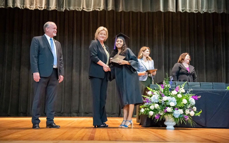 A Georgia Connections Academy graduate receives her high school diploma.