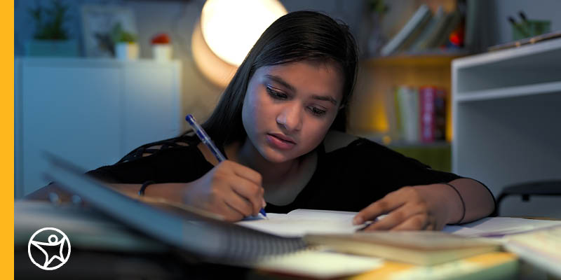 Young female student with her father Learning Coach working on an online assignment. 