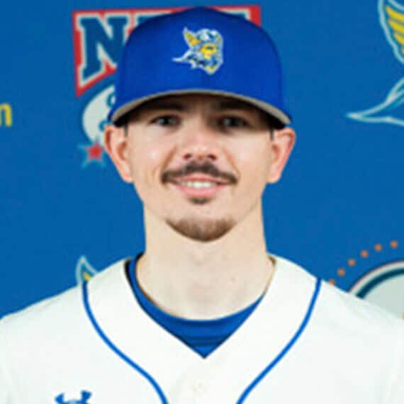Conner smiling in his baseball uniform