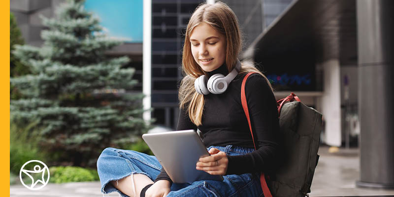 A high school senior in a black t-shirt from Connections Academy working on career plans with SNHU. 