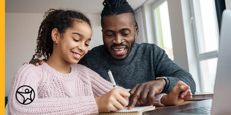 A father is helping his daughter study for an online school